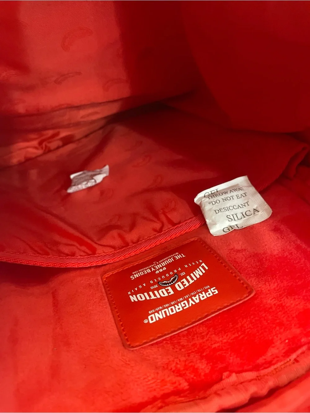 Sprayground Metallic Silver Logo Backpack with Red Accents